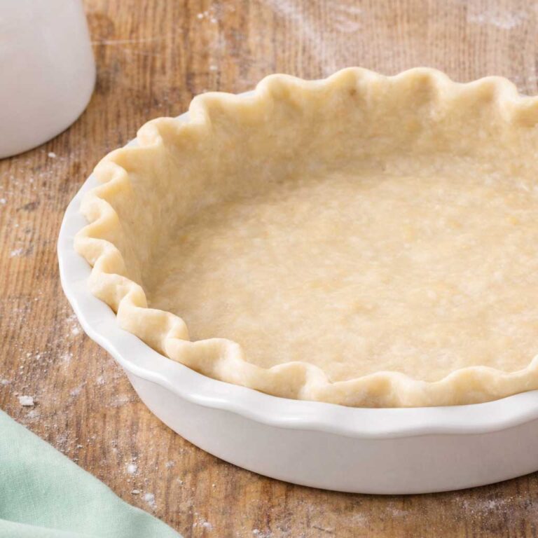 Unbaked pie crust in ceramic dish
