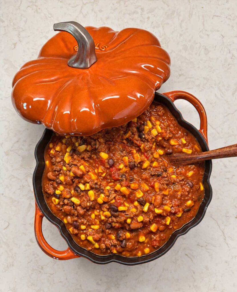 Hearty pumpkin turkey chili in an orange pumpkin Dutch oven pot