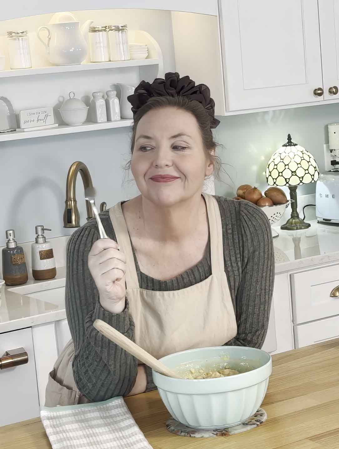 Jennifer tasting food in kitchen