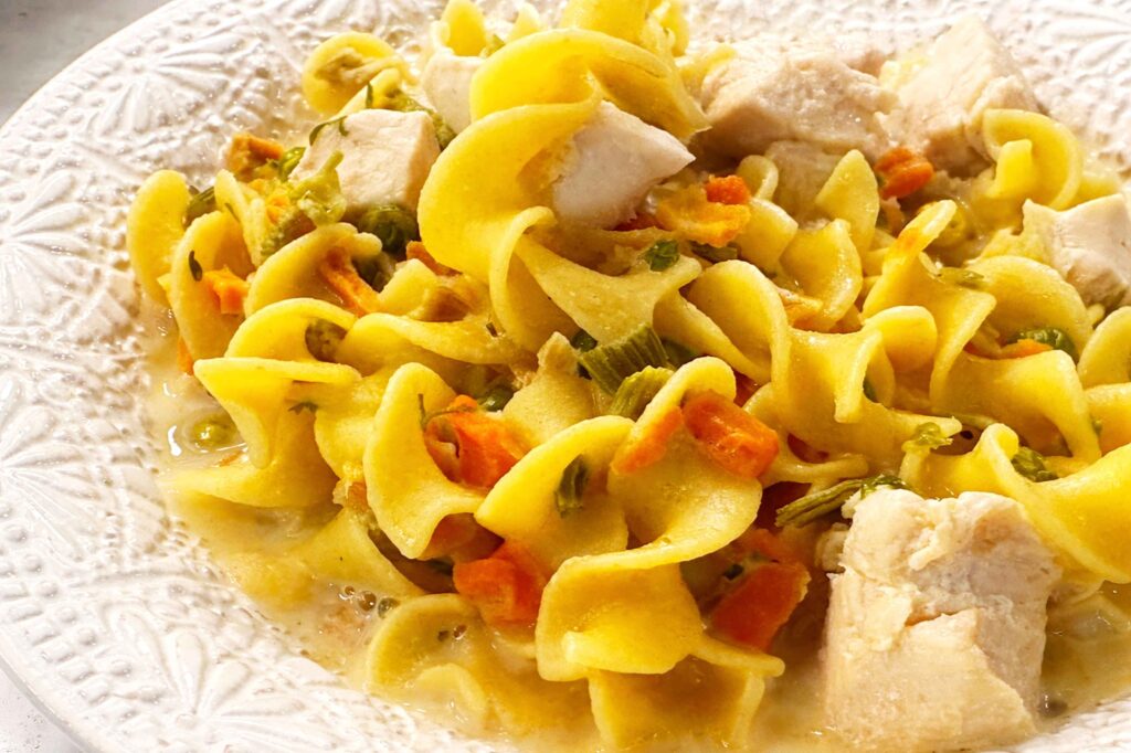Chicken noodle soup with chunks of chicken in a bowl