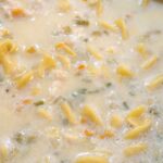 Chicken noodle soup simmering in pan