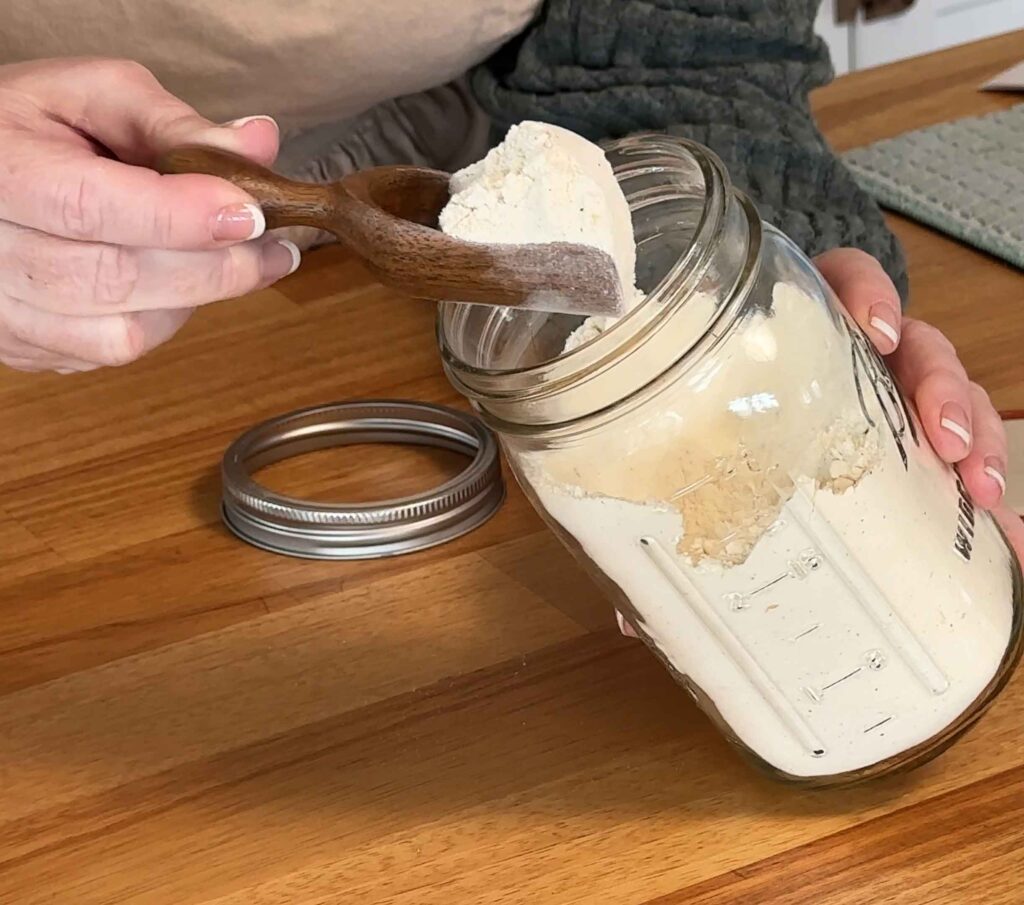 Scooping out some dry mix from the jar of soup mix