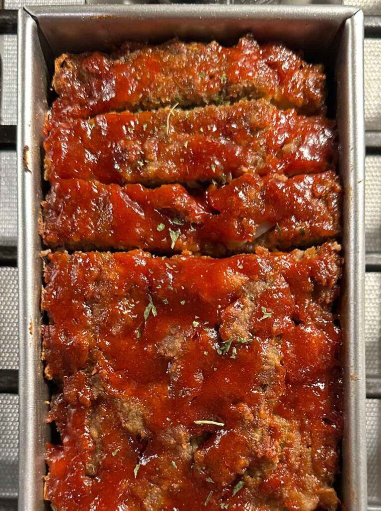 Classic meatloaf with a tangy tomato glaze in a pan