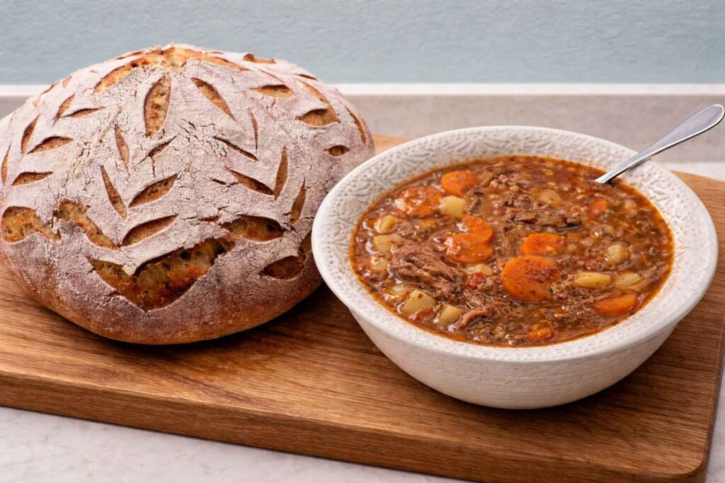 Loaf of sourdough bread with pantry beef stew