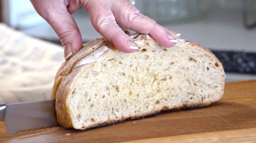 Slicing a loaf of sourdough bread