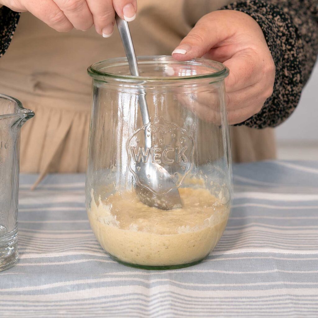 Mixing the sourdough starter with flour and water