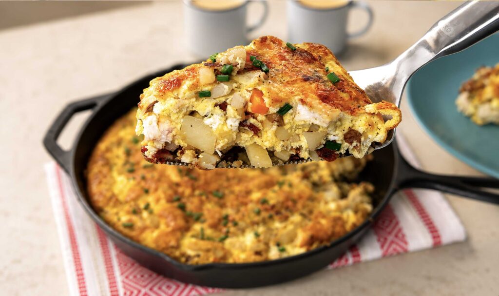 A slice of breakfast casserole from a skillet
