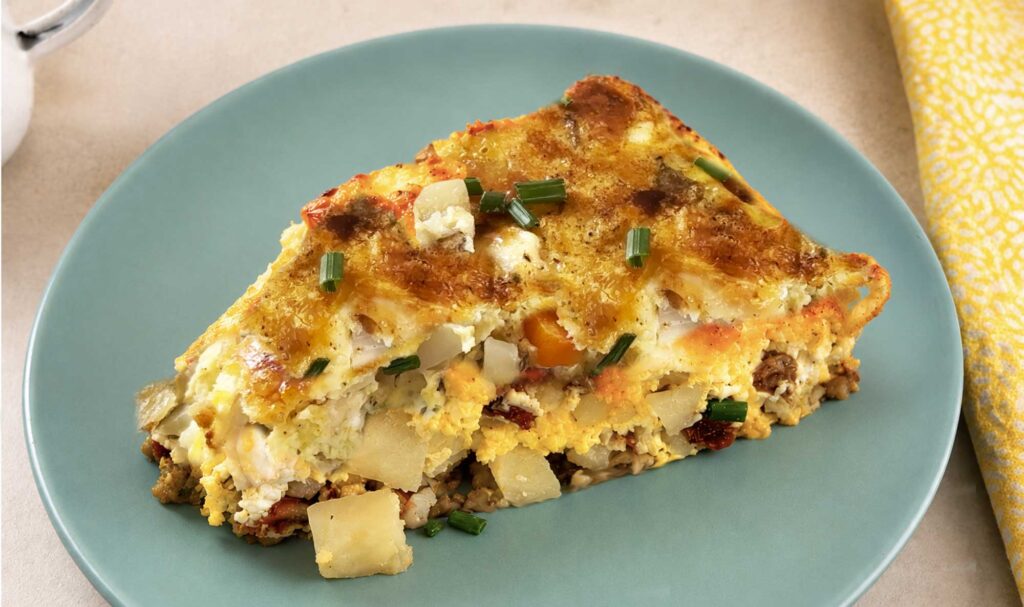 A slice of breakfast casserole on a blue plate