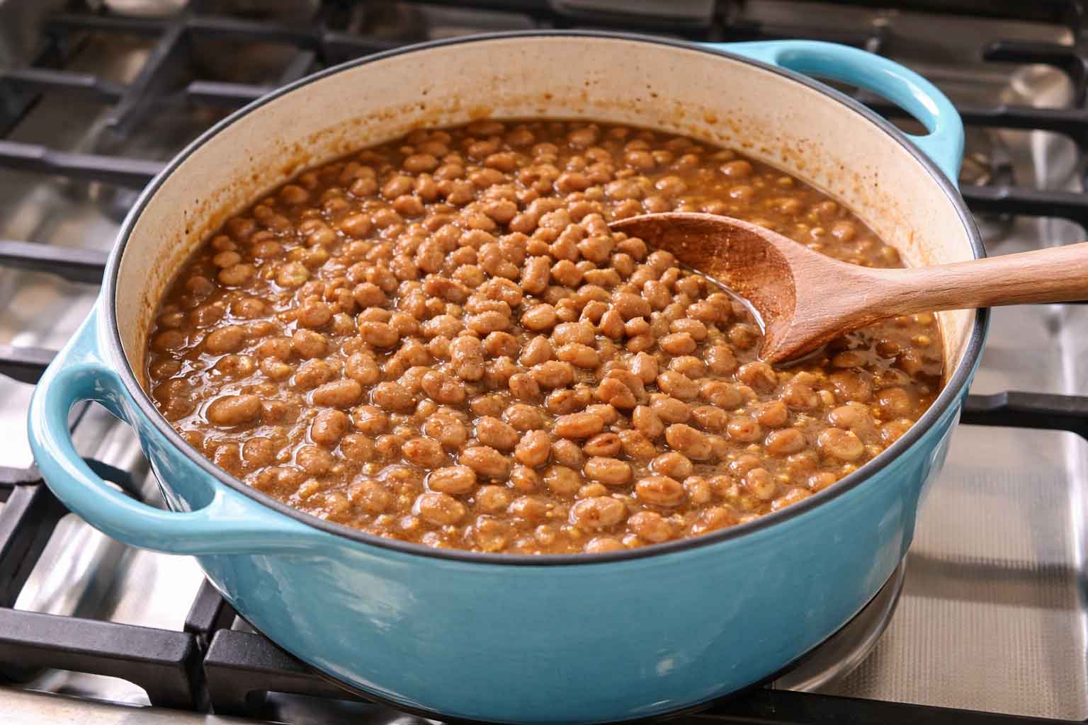 Brown Beans made with pinto beans in a blue dutch oven on the stove