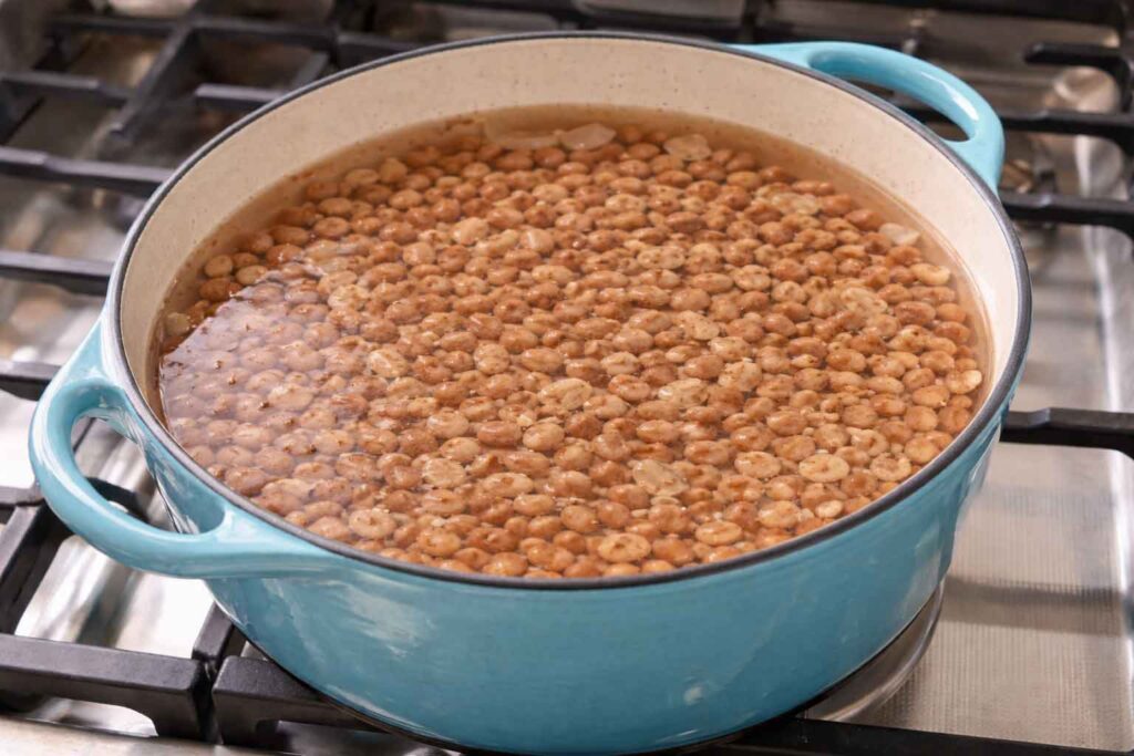 Pinto beans soaking in water in a big pot