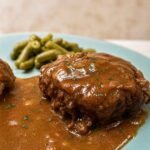Salisbury steak with gravy on a blue plate