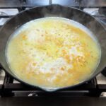 Chicken and rice simmering in skillet