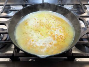 Chicken and rice simmering in skillet