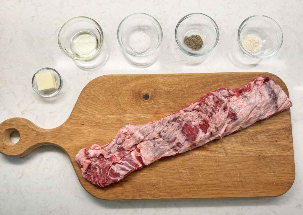 Skirt steak strip laid out on a cutting board