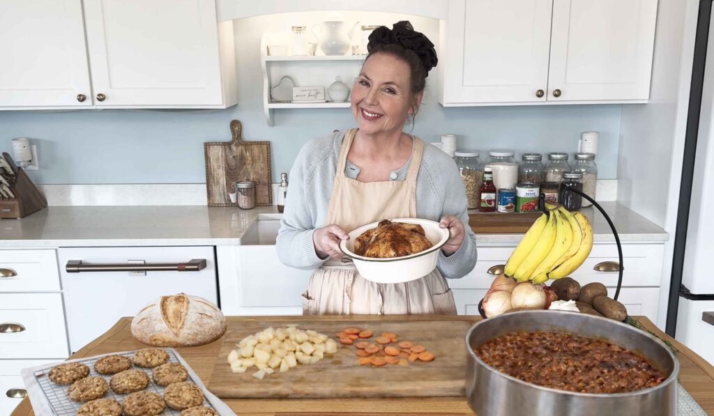 Jennifer in her kitchen with weekly meal challenge dishes