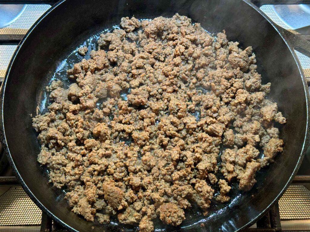 Browning the ground beef in a skillet