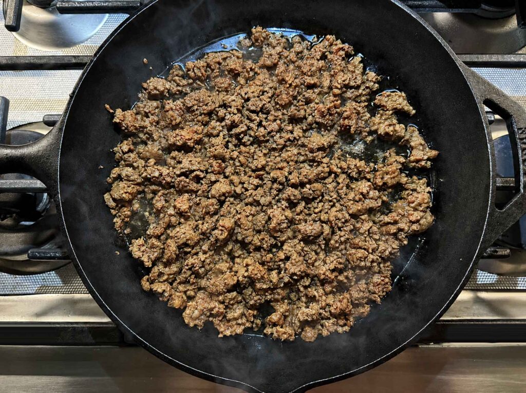 Browned ground beef in a cast iron skillet