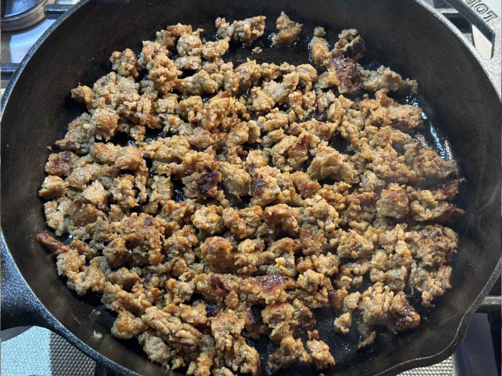 Deeply browned sausage in a cast iron skillet