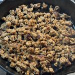 Browned sausage in a skillet