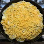 Hobo casserole with cheese sprinkled on top