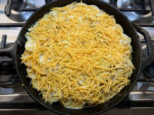 Hobo casserole with cheese sprinkled on top