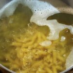 Cooking penne pasta in boiling water