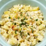 Creamy potato salad with chopped green onions on top