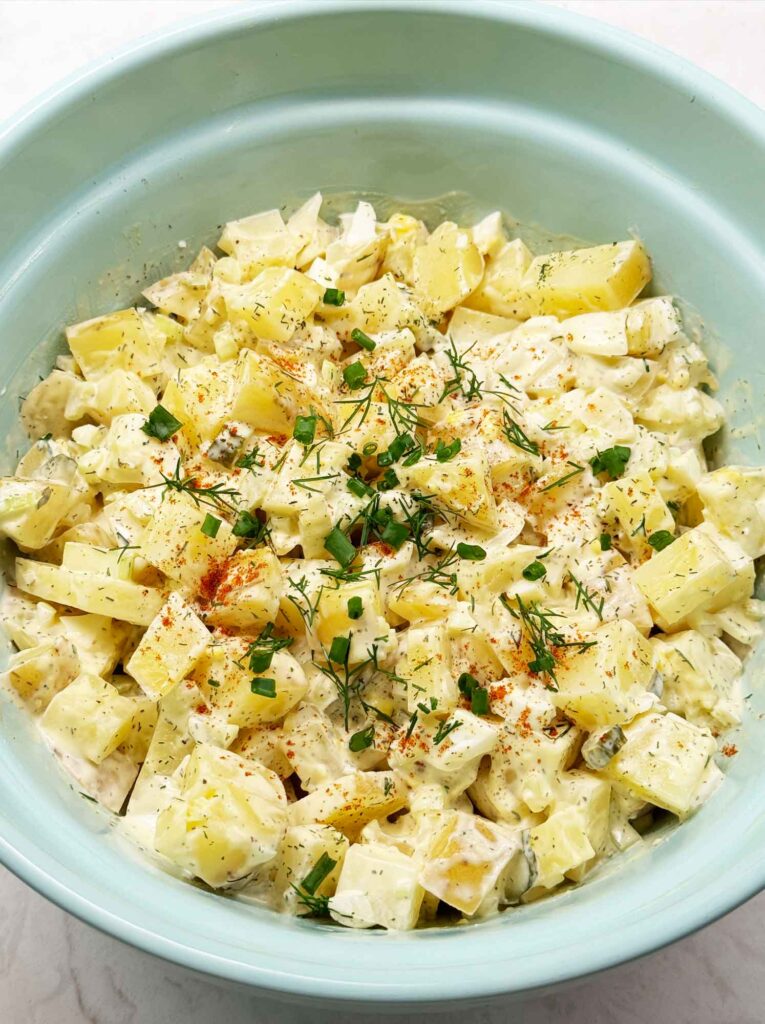 Creamy potato salad with chopped green onions on top