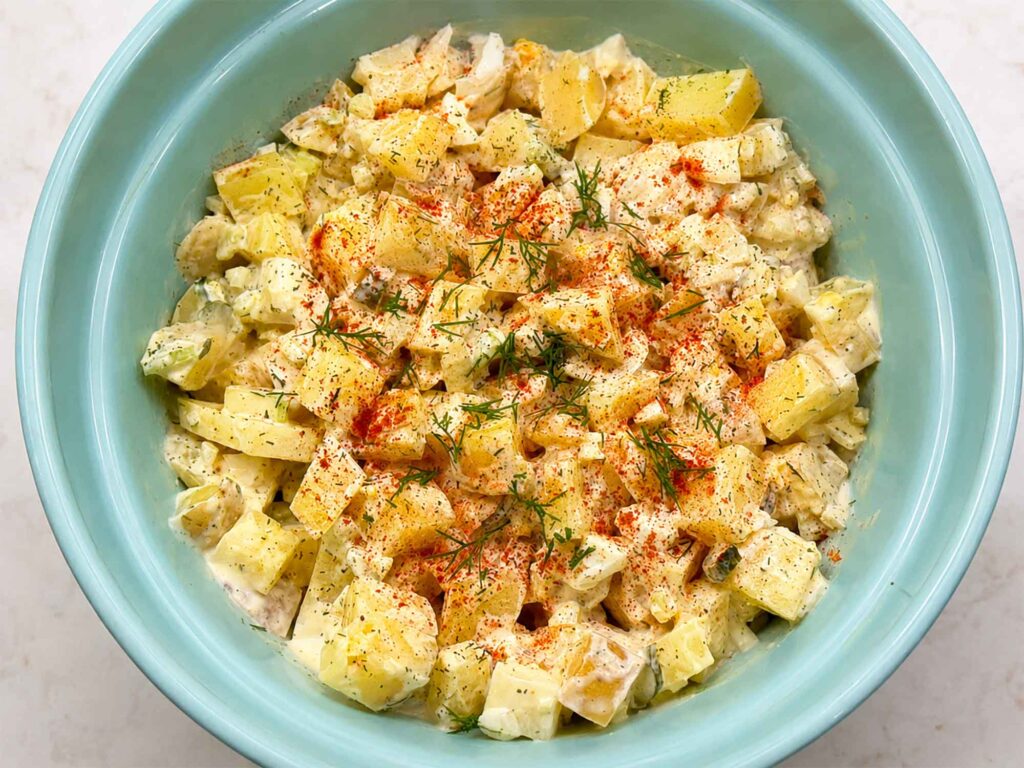 Creamy old fashioned potato salad in a blue bowl