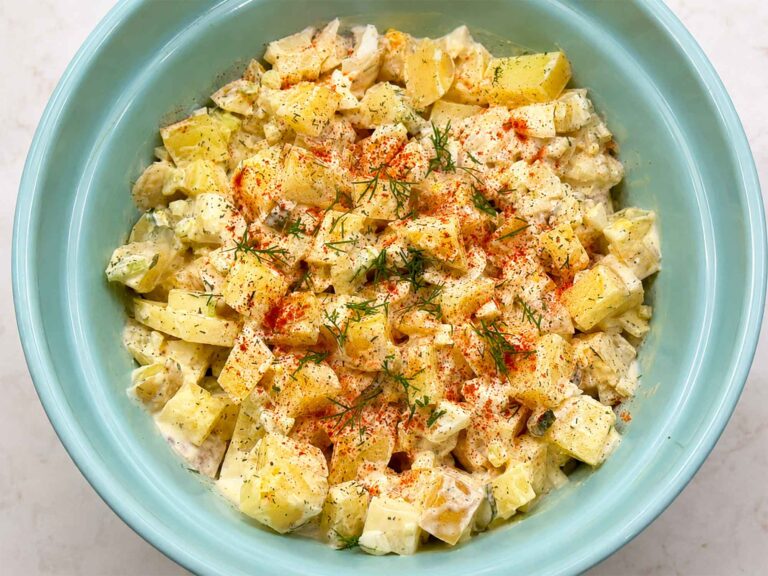 Creamy old fashioned potato salad in a blue bowl
