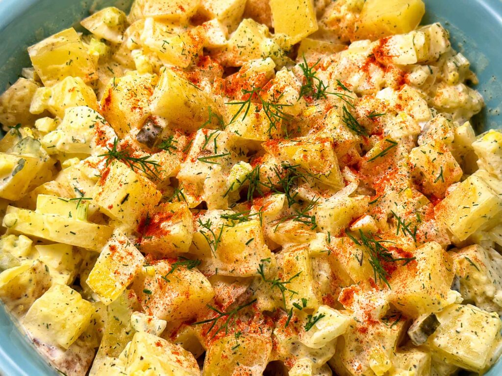 Closeup of potato salad in a blue bowl