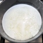 Rice gently boiling in pot