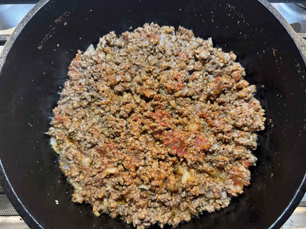 Tomato paste mixed in with ground beef and onions and garlic