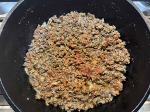 Tomato paste mixed in with ground beef and onions and garlic