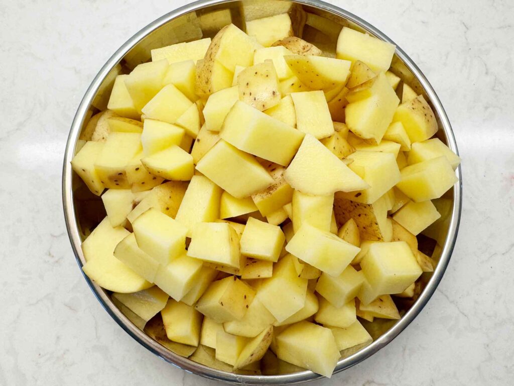 Bowl of cubed potatoes with the skin on