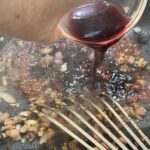 Adding red wine to skillet