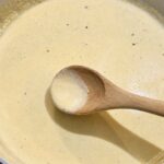 Best Homemade Alfredo Sauce (Just 10 Minutes!) Creamy alfredo sauce with a wooden spoon in a skillet