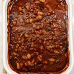 Baked beans in a white casserole dish