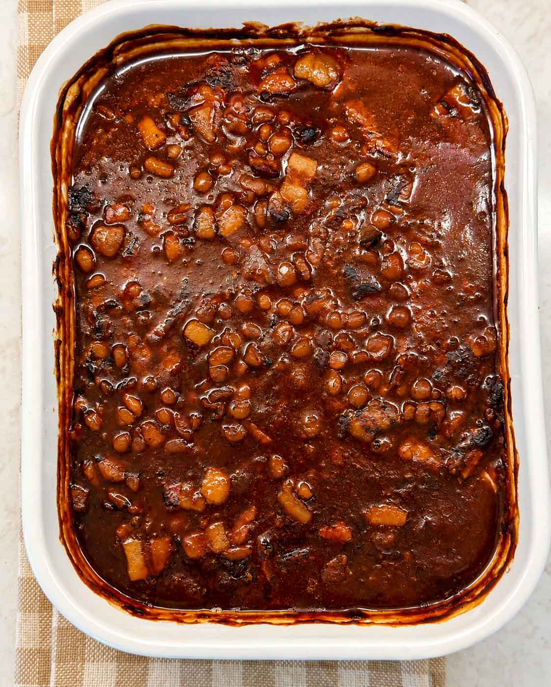 Baked beans in a white casserole dish