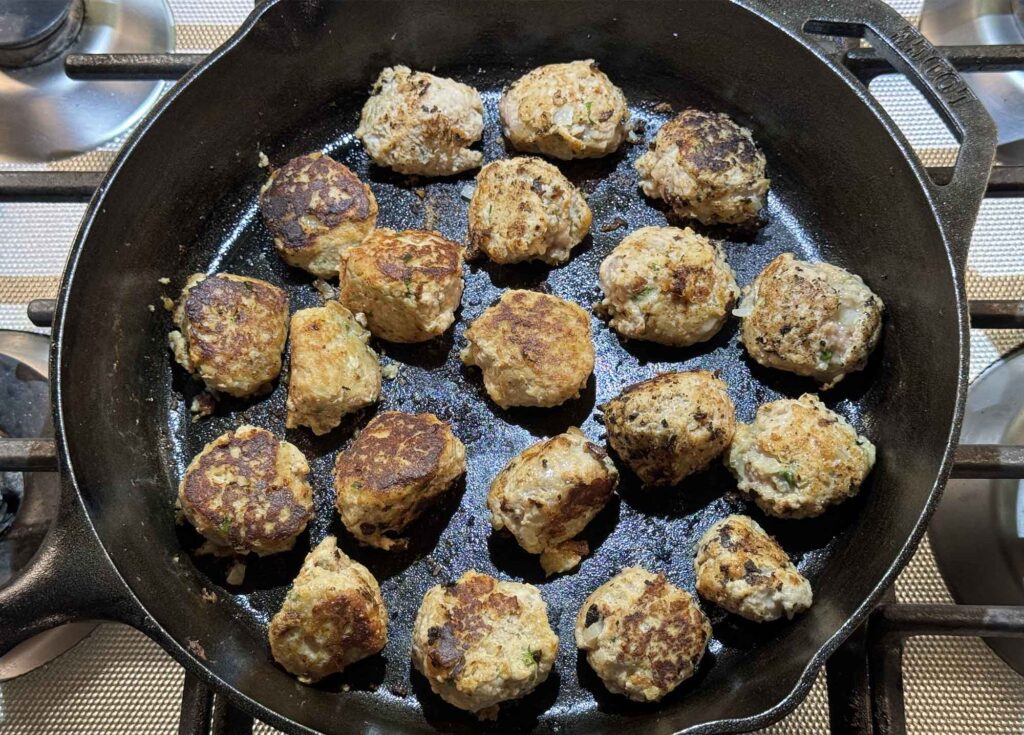 Browned turkey meatballs in a cast iron skillet