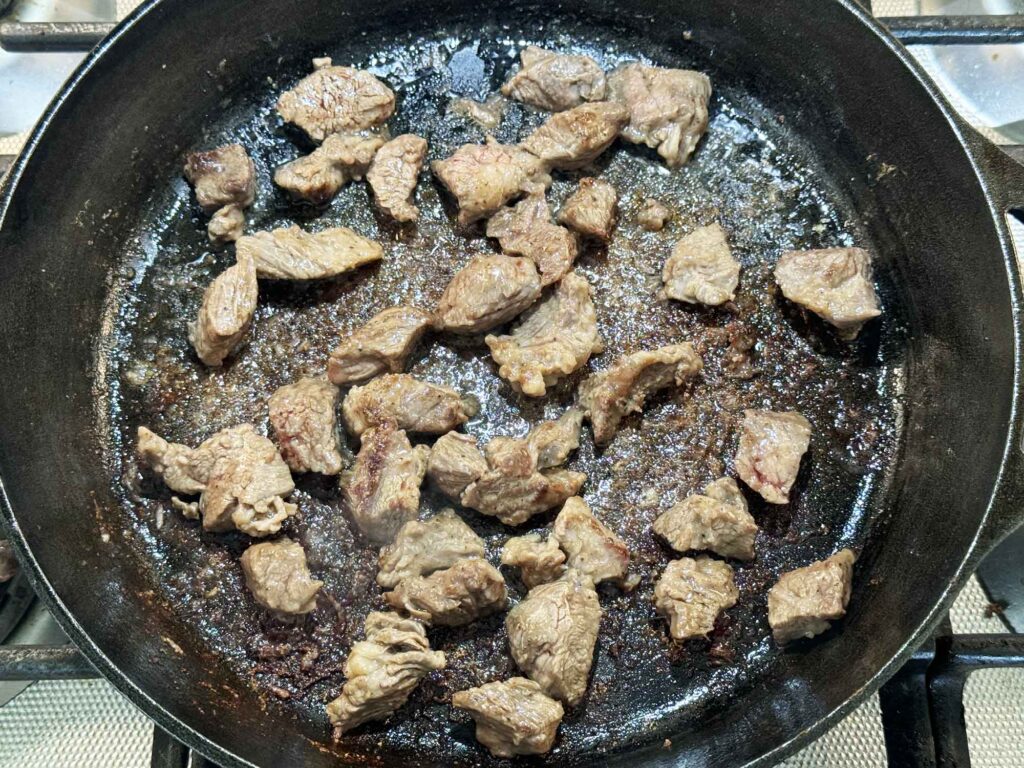 Browning the beef tips in a skillet