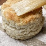 Brushing biscuits with butter