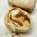 Cutting off a cinnamon roll
