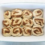 Cut cinnamon rolls in a greased baking dish