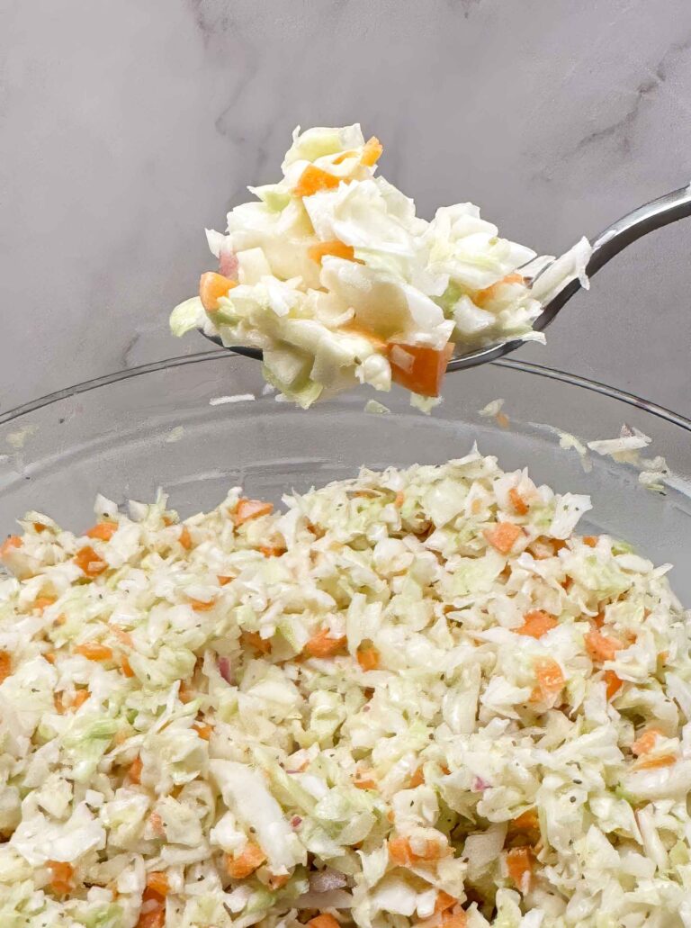 Coleslaw on a fork over a bowl