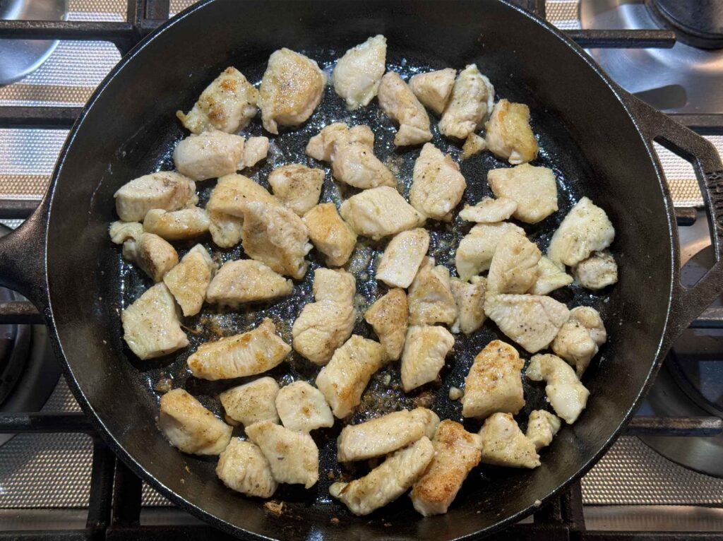 Cooked bite-sized chicken in skillet