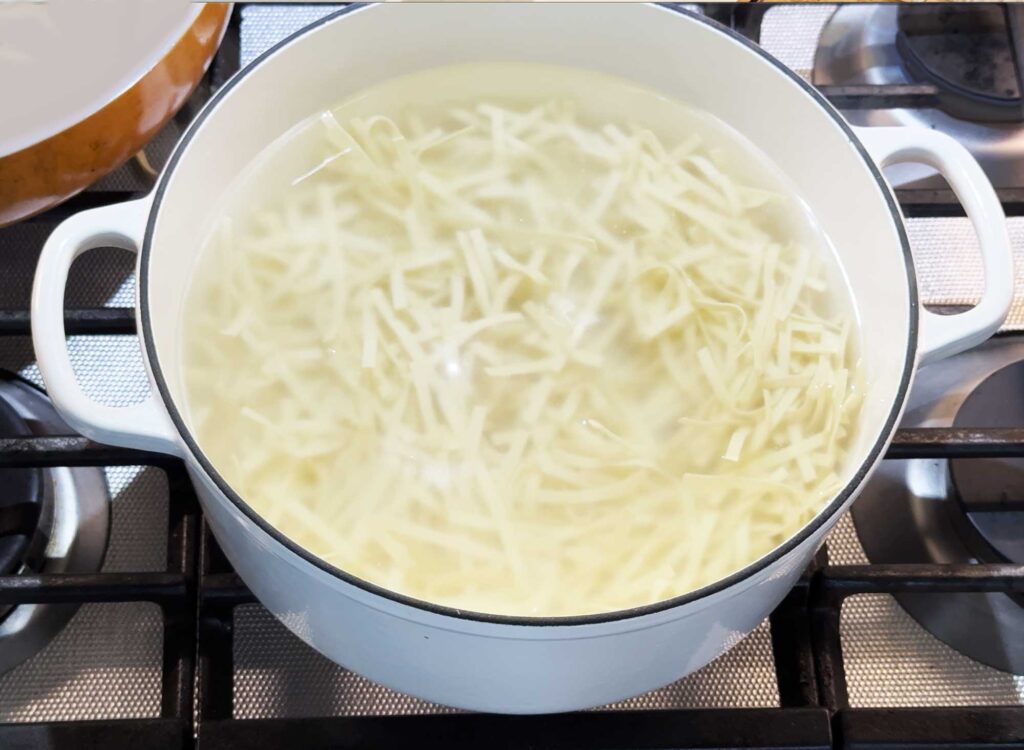 Cooking the fettucine noodles al dente in a big pot