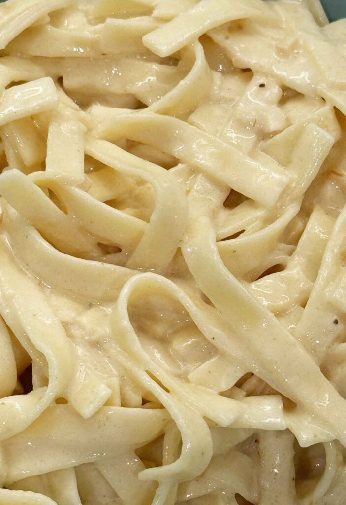 Creamy and smooth Alfredo sauce on fettuccine pasta