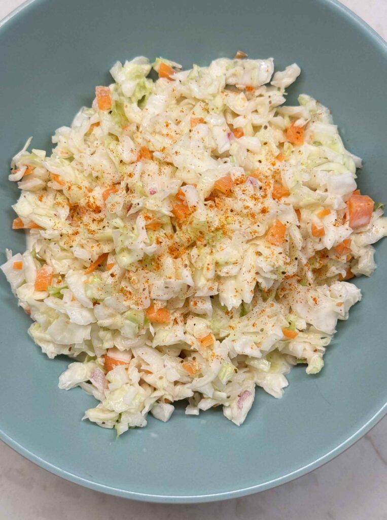 Creamy coleslaw in a blue bowl