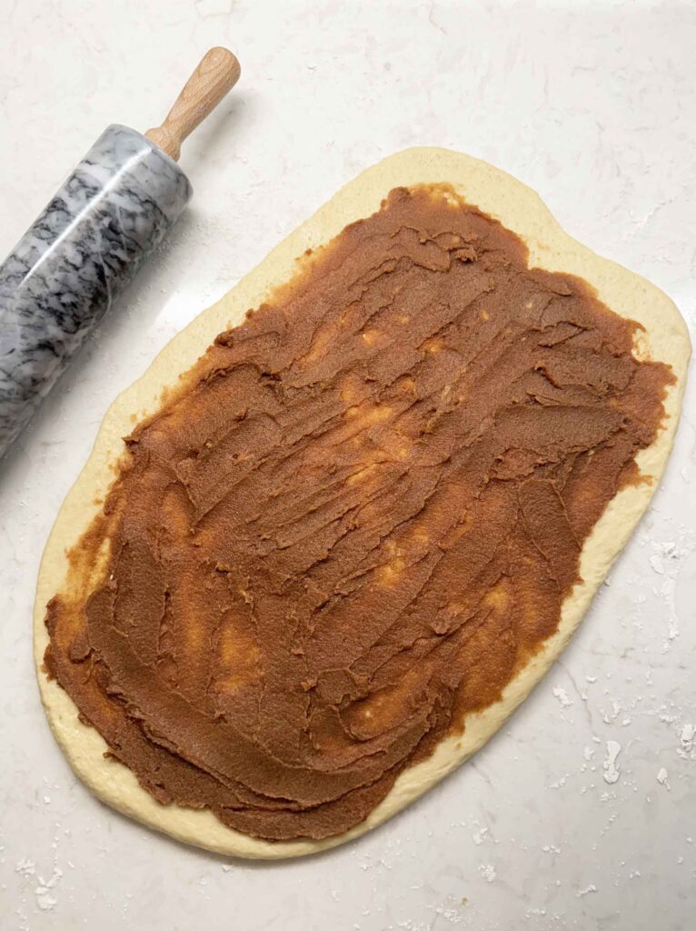 Cinnamon sugar filling spread out over the dough